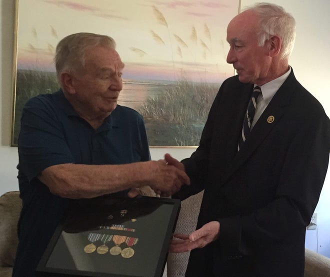 World War II veteran Reginald “Red” Morin, 89, of Danielson, accepts his war medals Friday from U.S. Rep. Joe Courtney, D-2nd District, in a ceremony at Morin's home.

Francesca Kefalas/For The Bulletin