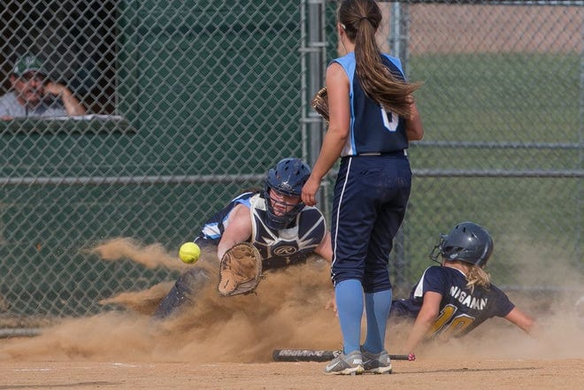 Greencastle-Antrim's Morgan Wagaman slides home safely as the throw arrives late to Conrad Weiser catcher Emma W. Price with pitcher Val Miller looking on during the sixth inning of Thursday's District 3-AAA softball third-place game at Carlisle High School.