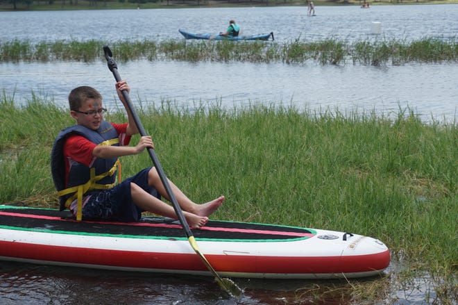 Will Morris, 9, of DeFuniak Springs, paddleboats at LakeFest Saturday.