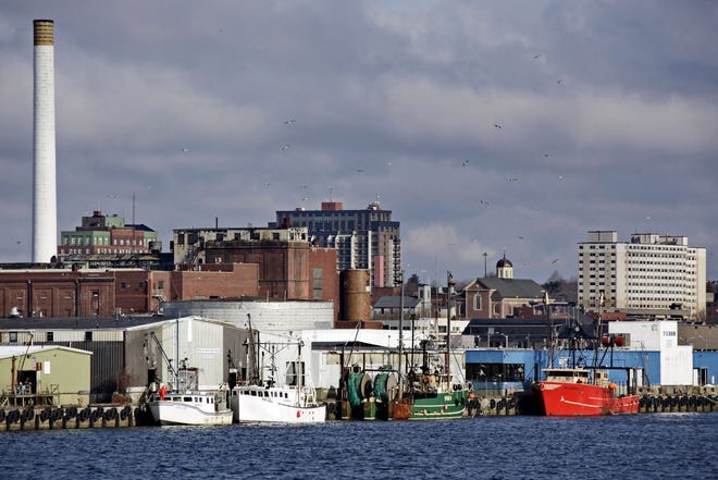 The proposed casino site, where the old NStar plant is, can be seen in the background with various fish processing plants in the foreground in New Bedford. PETER PEREIRA/STANDARD-TIMES File