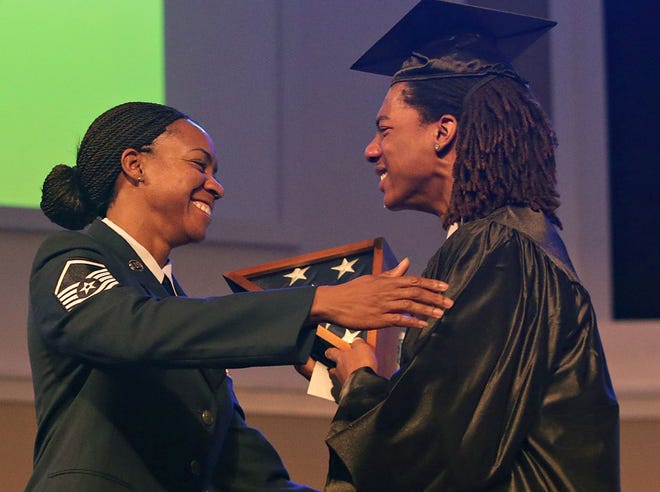 Master Sgt. Ashaunettae Young surprises her son, Tyjon Cuffee, during the North Bay Haven Charter Academy senior recognition ceremony on May 29.