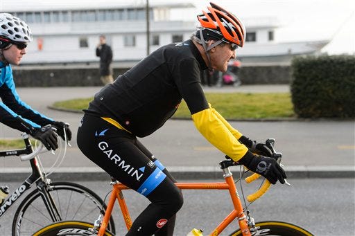 In this March 16, 2015 file picture U.S. Secretary of State John Kerry, rides a bike after a bilateral meeting with the Iranian Foreign Minister in Lausanne, Switzerland. Kerry is in stable condition in a Swiss hospital after suffering a leg injury in a bike crash outside Geneva Switzerland on Sunday, May 31, 2015. (Jean-Christophe Bott,Keystone via AP, file)