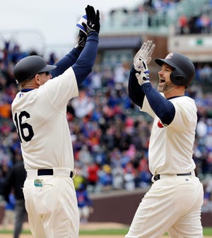 Chicago Cubs' David Ross, right, celebrates with first base coach Brandon Hyde after hitting the game-winning single against the Kansas City Royals during the 11th inning of a baseball game, Sunday, May 31, 2015, in Chicago. The Cubs won 2-1. (AP Photo/Nam Y. Huh)