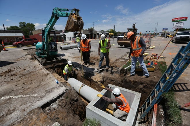 Nowak construction workers carefully line up a reinforced concrete pipe for a storm water line Wednesday afternoon, May 27, 2015, in the 2400 block of Main Street.
