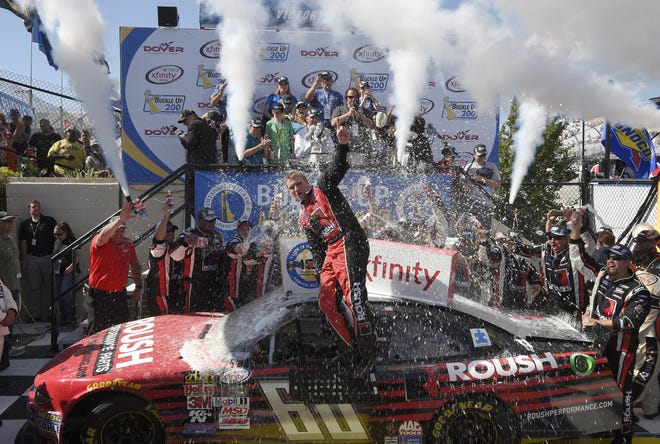 Chris Buescher celebrates in Victory Lane after he won the NASCAR Xfinity series auto race, Saturday at Dover International Speedway in Dover, Del. (AP Photo/Nick Wass)