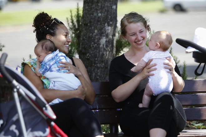 Stephanie Starks (left) and Autumn Henry-Darwish enjoy the sunny afternoon at Alton Baker Park on Thursday. Both favor a smoking ban in parks. “It’s not something you can contain to your own space and not affect other people,” Starks said. (Andy Nelson/The Register-Guard)