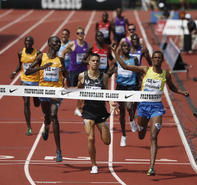 Ayanleh Souleiman crosses the finish line ahead of Matt Centrowitz, center, and Asbel Kiprop to win the Bowermna Mile at the Prefontaine Classic at Hayward Field in Eugene on Saturday, May 30, 2015. Souleiman won the race with a time of 3:51.10. (Andy Nelson/The Register-Guard)