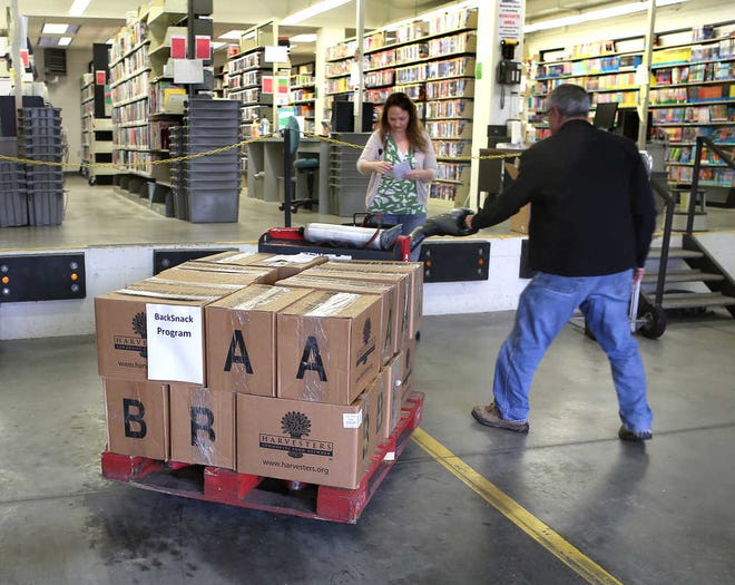 A pallet containing food for the BackSnack program is brought into the bookmobile loading dock. The Topeka and Shawnee County Public Library is helping provide food to children this summer.