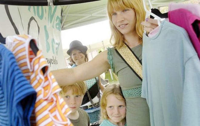 In this file photo, Lisa Handy shops for clothes designed by Brittany Rose with her children Nura and Sebastian at Rose's business' booth, RosMari Brand, at the Chicks Along the Canal event at Canal Place in Little Falls. The Canal Celebration event featured women vendors from around the area offering their arts, crafts and services as musicians performed and shoppers browsed. GATEHOUSE NEW YORK FILE PHOTO