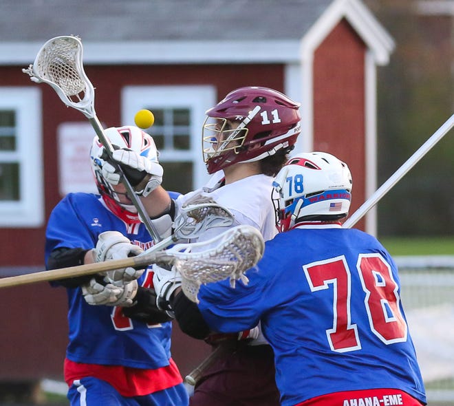 Portsmouth High School's John Franks (11) is surrounded by Winnacunnet defenders Ryan Moskevich (74) and Sean Cotter (78) during a Division II lacrosse game between the teams in Portsmouth last month. File photo by Matt Parker