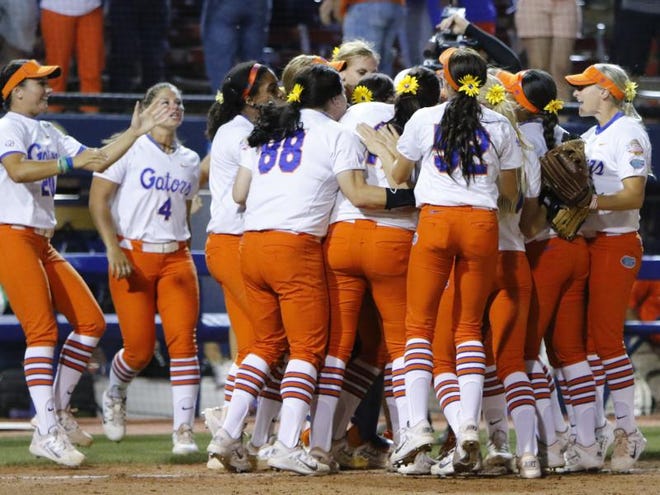 Florida celebrates after defeating Michigan during game one of the NCAA Women's College World Series Championship in Oklahoma City, Monday, June 1, 2015. Florida won 3-2.