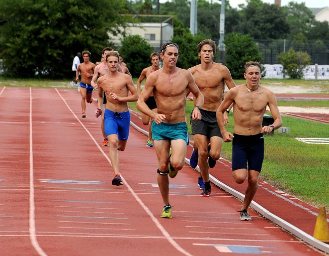 The UNCW Seahawks cross country team run on the track during practice on campus in September. StarNews file photo