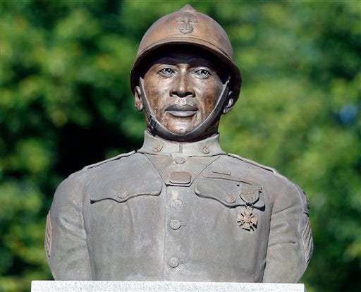 In this July 10, 2014, file photo, a statue of Henry Johnson is displayed in the Arbor Hill neighborhood in Albany, N.Y. Two World War I Army heroes, Sgt. William Shemin and Johnson are finally getting the Medal of Honor they may have been denied because of discrimination, nearly 100 years after bravely rescuing comrades on the battlefields of France. President Barack Obama plans to posthumously bestow the nation's highest military honor on both men for their actions in 1918 during a White House ceremony Tuesday, June 2, 2015. (AP Photo/Mike Groll, File)