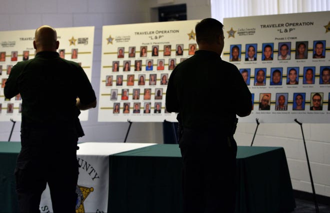 Deputies look at boards showing mugshots from the arrests made by a joint operation between Lake County Sheriff’s Office and Polk County Sheriff’s Office during a press conference on Tuesday at the Institute of Public Safety in Tavares.