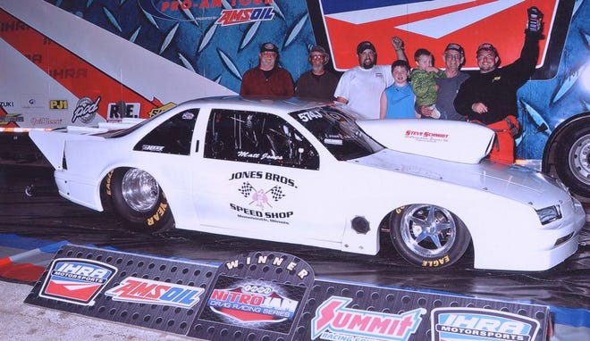 The Jones family celebrates after taking second overall in the Top Sportsman class at the IHRA Nitro Jam Summer Nationals at Cordova International Raceway over the weekend. From right are: Mikey, Mike, Grady, Slater and Matt Jones, standing behind the 1,300-horsepower 1990 Beretta that they used to compete in the nationwide drag racing series.