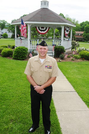 Dean Custozzo of Ellwood City, a petty officer first class involved with gathering top-secret intelligence for the Navy Reserve, stands in front of the Gazebo off Jefferson Street in Ellwood City.