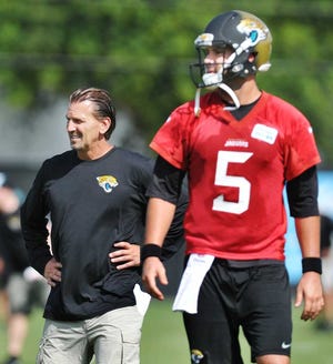 Will.Dickey@jacksonville.com--05/27/15--Offensive coordinator Greg Olson (left) and quarterback Blake Bortles watch a pass during an NFL Jaguars offseason OTA practice Wednesday, May 27, 2015 in Jacksonville, Florida. (The Florida Times-Union, Will Dickey)
