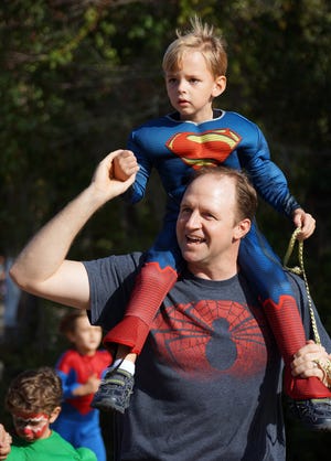 Jamie Parker/Bryan County Now
Ethan Schmucker of Savannah, aka Superman, gets a ride on the shoulders of his dad Rodney in the one-half-mile fun run at the Warriors 4 William event last year.