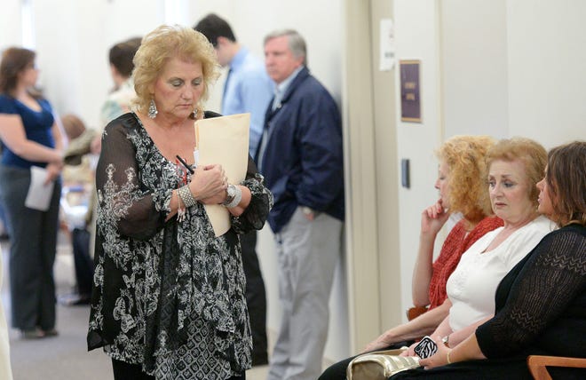 People wait in a courtroom hallway for the sentencing of Christina George on Wednesday morning at the Beaver County Courthouse.