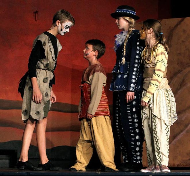 Hyena Banzai (Jacob Hooks) confronts young Simba (Liam Buckner), as ZaZu (Mikayla Hensle) and young Nala look on in a scene from the impACT Theatre's production of 'The Lion King.'