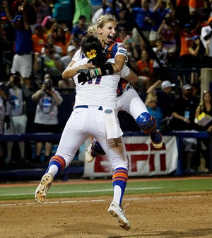 Florida Gators pitcher Lauren Haeger and catcher Aubree Munroe celebrate after defeating the Michigan Wolverines 4-1 to win the Women's College World Series on Wednesday in Oklahoma City.