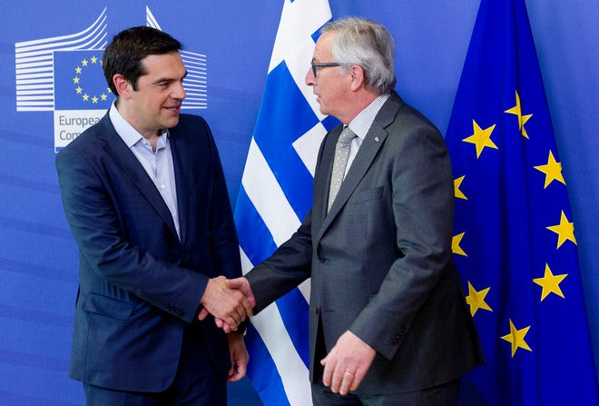 European Commission President Jean-Claude Juncker, right, shakes hands with Greek Prime Minister Alexis Tsipras as they arrive for a meeting at EU headquarters in Brussels on Wednesday, June 3, 2015. Greece's prime minister meets European Commission President Jean-Claude Juncker in Brussels on Wednesday, June 3, 2015 to discuss his radical left-led government's proposal to secure a vital, long-overdue agreement with the country's bailout lenders. (AP Photo/Thierry Monasse)