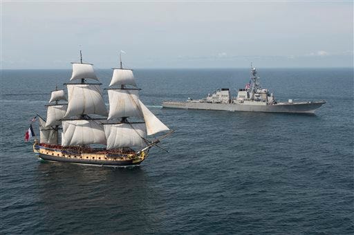 This Tuesday, June 2, 2015 image provided by the U.S Navy shows the Arleigh Burke-class guided-missile destroyer USS Mitscher, right, and the French tall ship replica Hermione, off the Virginia Capes on the East Coast of the United States. The original Hermione brought French Gen. Marquis de Lafayette to America in 1780 to inform Gen. George Washington of France's alliance and impending support of the American Revolutionary War. The symbolic return of the Hermione will pay homage to Lafayette and the Franco-American alliance that brought victory at the Battle of Yorktown in 1781. The Hermione will visit Yorktown, Va., June 5, continuing up the Eastern Seaboard, visiting cities of Franco-American historical significance. (Petty Officer 1st Class Michael Sandberg/U.S. Navy via AP)