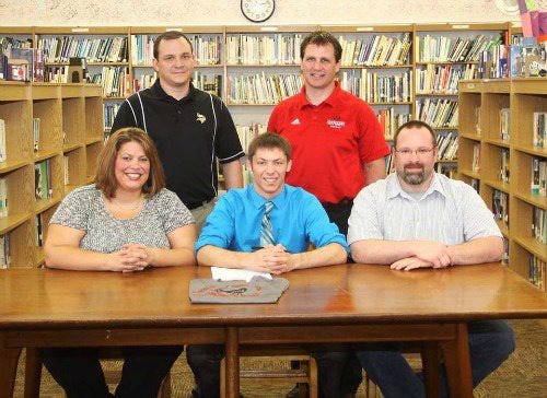 Kahle Scheenks, shown here with his parents and Bronson wrestling coach Chad Butters along with the Davenport University head coach, recenlty signed his letter of intent to wrestler for DU.



SUBMITTED PHOTO