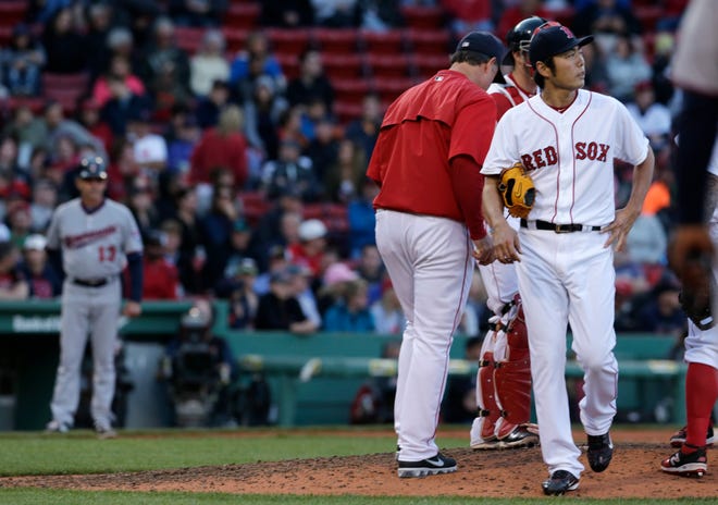Boston closer Koji Uehara walks off the mound after manager John Farrell removed him in the ninth inning of Thursday's game against the Minnesota Twins at Fenway Park. AP photo