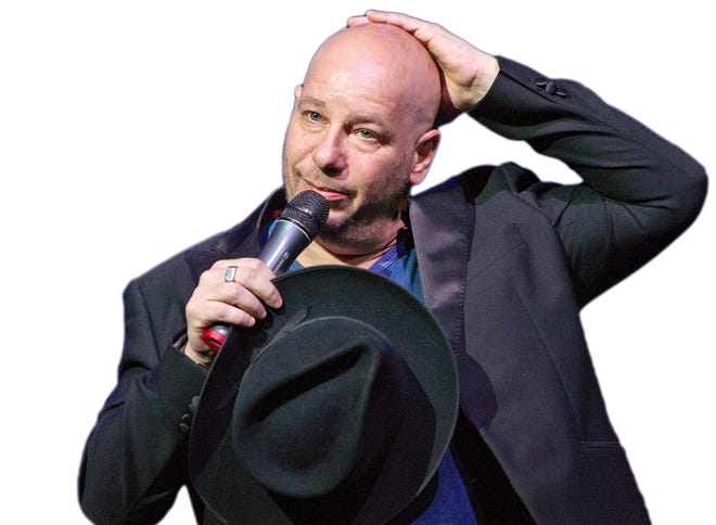 Jeff Ross shows off his bald head to the crowd at a show in May.