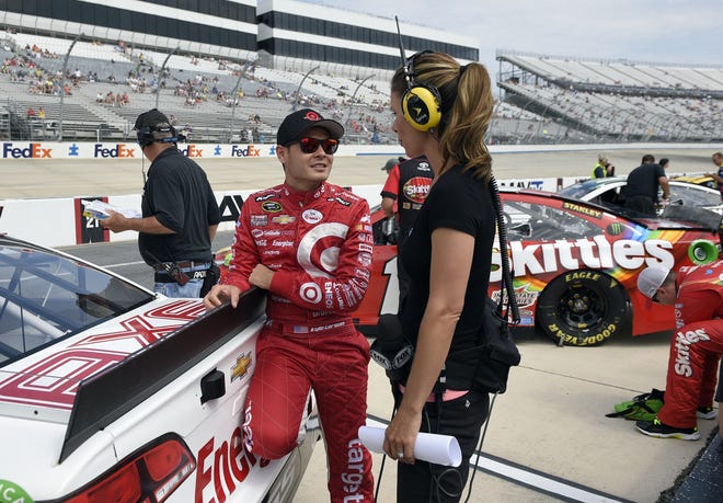 Kyle Larson, left, talks with Jamie Little, right, before qualifying for a NASCAR Sprint Cup series auto race on May 29 at Dover International Speedway in Dover, Del. (AP Photo/Nick Wass)