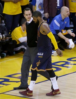 Cleveland Cavaliers guard Kyrie Irving (2) walks off the floor after being injured during overtime of Game 1 of basketball's NBA Finals against the Golden State Warriors in Oakland, Calif., Thursday, June 4, 2015. The Warriors won 108-100. (AP Photo/Eric Risberg)