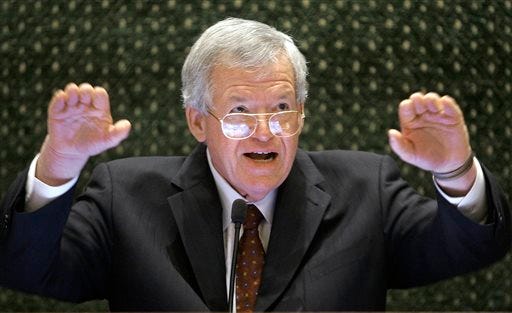 FILE - In this March 5, 2008, file photo, former U.S. House Speaker Dennis Hastert speaks to lawmakers on the Illinois House of Representatives floor at the state Capitol in Springfield, Ill. A federal judge on Tuesday delayed former U.S. House Speaker Dennis Hastert's first court appearance until June 9 following his indictment in Chicago. The Illinois Republican was scheduled to be arraigned Thursday, but the hearing has now been pushed back. The change was made without explanation in a one-sentence court filing by U.S. District Judge Thomas M. Durkin's clerk. (AP Photo/Seth Perlman, File)