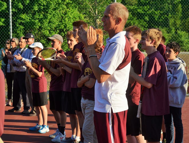 Portsmouth High School boys tennis coach Seab Stanton, forefront, applauds Lebanon's players during an awards ceremony for Thursday's Division II championship match in Bedford. The Clippers — with no seniors in their lineup — capped a perfect season with a 5-4 win.