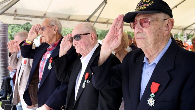 Army veteran Jack Bernstein, right, salutes with nine other veterans that were given the French Legion of Honor by Consul General Phillippe Letrilliart during The Boynton Veterans Council D-Day Observance at Veteran’s Memorial Park in Boynton Beach on June 5, 2015. (Richard Graulich / The Palm Beach Post)