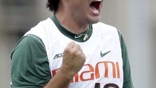 Miami relief pitcher Bryan Garcia (19) celebrates after a 3-2 win against VCU at the end of the ninth inning in the super regionals of the NCAA college baseball tournament, Friday, June 5, 2015, in Coral Gables, Fla. (AP Photo/Alan Diaz)