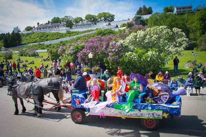 This 2014 file photo shows one of the horse-drawn floats in the Lilac Festival Grand Parade on Mackinac Island. This year, the 66th annual parade will begin at 4 p.m. on Sunday, June 14. The 10-day festival begins today.