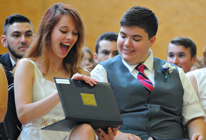 Sasha Scudder shows her excitement as she opens her diploma with classmate Hester Krog on Saturday, June 6, 2015, during the 86th Solebury School commencement.