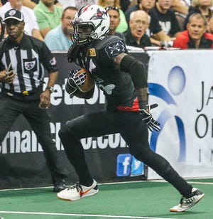 Sharks wide receiver Jeron Harvey runs the ball after a catch against the Predators during the first half of Jacksonville's victory.