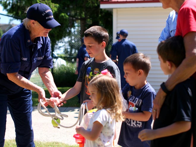 United States Coast Guard Auxiliary's Bonnie Lindke shows Jacob DeWitt, 8, how to properly handle and throw a line to someone who may be in need of help on the water. Rob Wetterholt Jr./Sentinel Staff