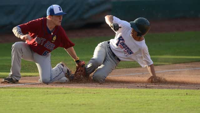 Kinston Post 43's Robert Blake slides into third base as Jacksonville Post 265 Scottie White tries to apply the tag Friday in the second inning at Grainger Stadium.