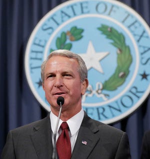 Dr. Kyle Janek, Texas health and human services executive commissioner, addresses a news conference in Austin on Oct. 17, 2014. Janek is on his way out as head of the largest agency in Texas, months after a report ordered by Gov. Greg Abbott urged changes following a contracting scandal.