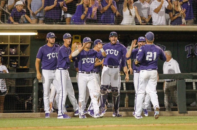 TCU pitcher Brian Trieglaff (21) is congratulated by teammates in the tenth inning at the Fort Worth Regional of the NCAA college baseball tournament in Fort Worth,Texas, on Monday, June 1, 2015. TCU won 9-8. (AP Photo/Tim Sharp)