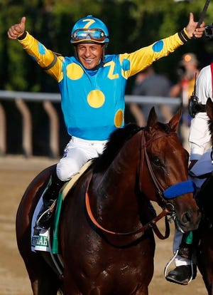 Victor Espinoza celebrates atop American Pharoah after winning the 147th running of the Belmont Stakes horse race at Belmont Park, Saturday, June 6, 2015, in Elmont, N.Y. American Pharoah is the first horse to win the Triple Crown since Affirmed won it in 1978.(AP Photo/Julio Cortez)