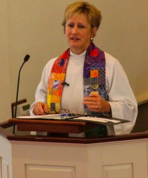 Rev. Mary E Westfall opened the memorial service for former Oyster River High School teacher Lou Mroz Saturday at the Durham Community Church. Photo by AJ St. Hilaire/Fosters.com