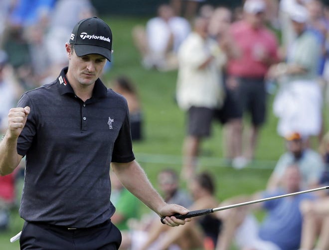 Justin Rose, of England, reacts after making a birdie on the 14th hole during the third round of the Memorial golf tournament Saturday in Dublin, Ohio.