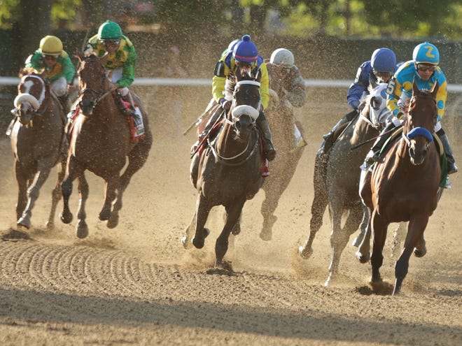 American Pharoah, with Victor Espinoza up, right, rounds the fourth turn at the 147th running of the Belmont Stakes horse race Saturday, June 6, 2015, in Elmont, N.Y. American Pharoah is the first winner of the Triple Crown since Affirmed won it in 1978.