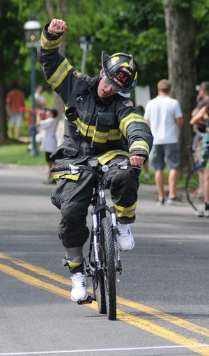 Steve Miller of the Riverton Fire Company makes his way over the finish line during the Firefighter's Fun Race at the last year's race.
