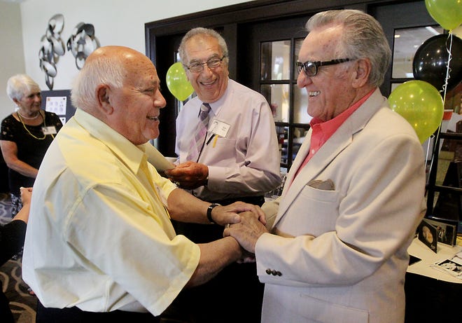 Jake Bedrosian, left, of Cranston, greets Robert Souza, of Warwick, on Sunday at the 60th reunion of Central High School's Class of 1955. In the middle is classmate Bob Rico, of Smithfield. The Providence Journal/Glenn Osmundson