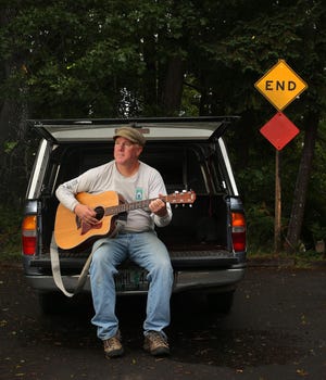 Faced with the end of his job, Carl Falsgraf took an impromptu 49-day road trip, driving across America with his guitar in a pickup nicknamed “Muddy.” Falsgraf wrote a book, “Highway Blues,” about his adventures. (Brian Davies/The Register-Guard)